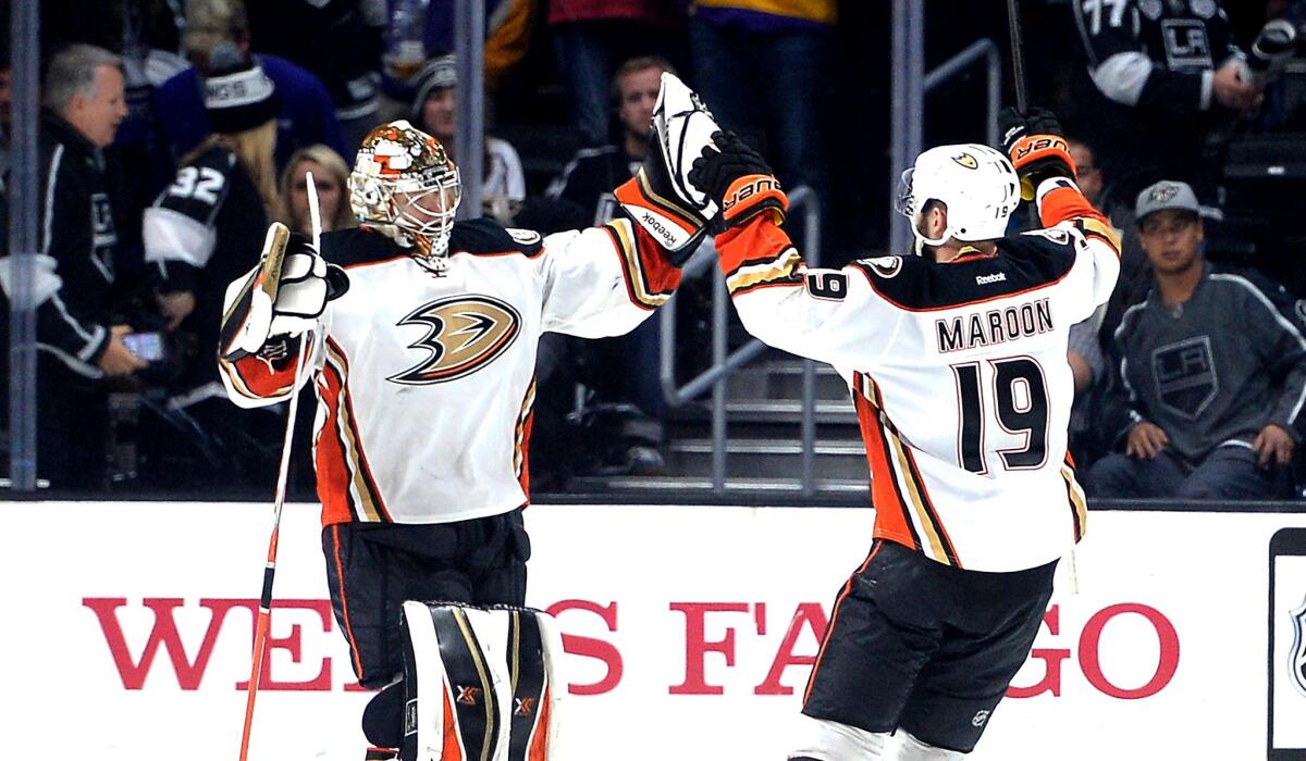 Ducks goalie Frederik Andersen celebrates a 3-2 overtime shootout victory against the Kings with teammate Patrick Maroon on Saturday night at Staples Center.