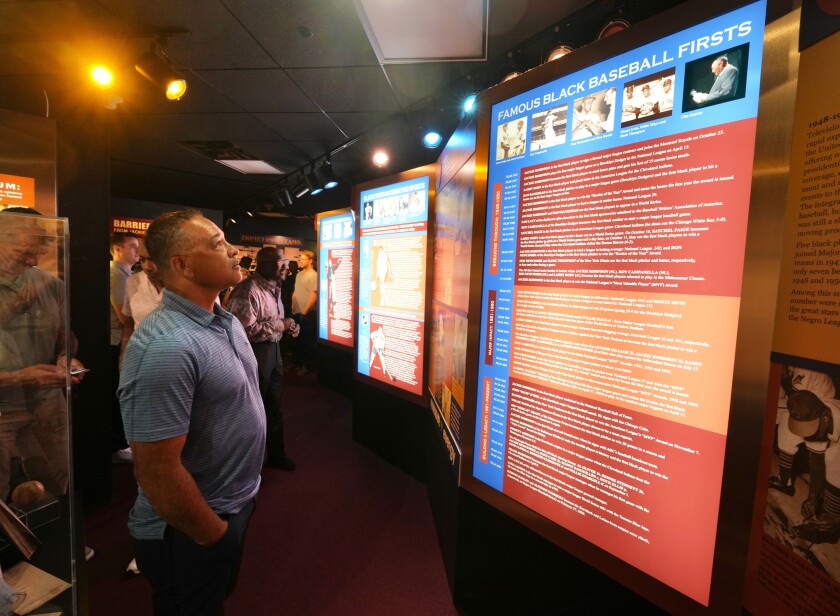 Dodgers manager Dave Roberts looks at an exhibit at the Negro Leagues Baseball Museum on Saturday.