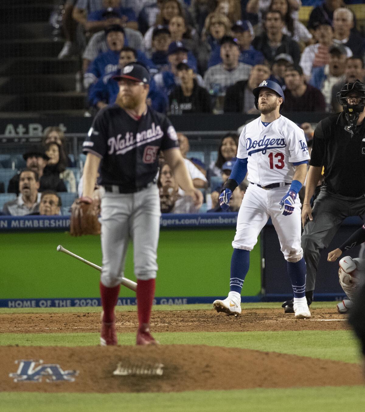 Los Angeles Dodgers first baseman Max Muncy watches his home run ball against Washington Nationals relief pitcher Sean Doolittle in the 7th inning.
