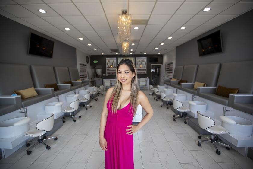 TUSTIN, CA -- FRIDAY, MAY 8, 2020: Christie Nguyen, who co-owns Studio 18 Nail Bar with her brother, Michael Nguyen and parents Michelle Le and Alan Nguyen, is photographed at the closed Tustin business Friday, May 8, 2020. Gov. Newsom says coronavirus started in a nail salon and now Asian Americans are afraid that they will go out of business. Photo taken in Tustin, CA, on May 8, 2020. (Allen J. Schaben / Los Angeles Times)