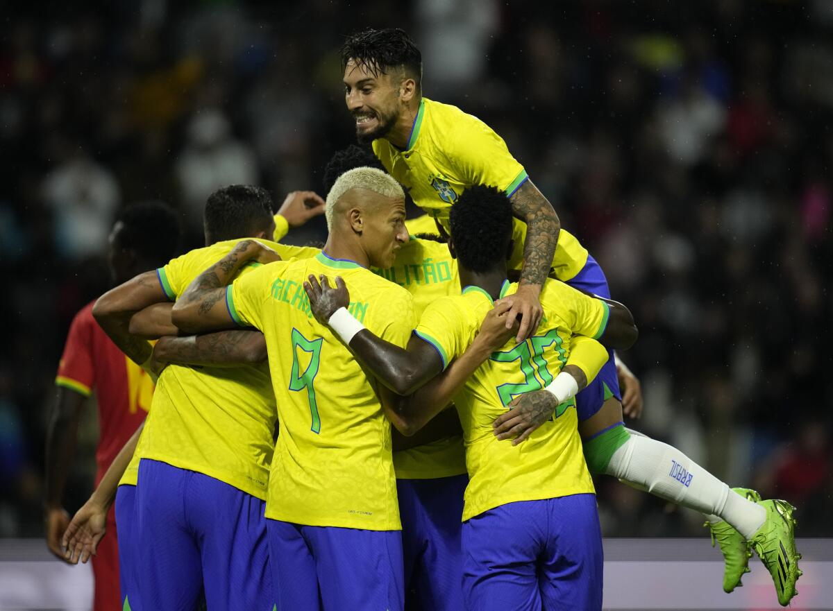 Brazil players celebrate after their teammate Marquinhos scores his side's opening goal during the international friendly soccer match between Brazil and Ghana in Le Havre, western France, Friday, Sept. 23, 2022. (AP Photo/Christophe Ena)
