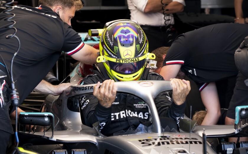 Mercedes Team driver Lewis Hamilton, of Britain, slips into this car during the first practice session at the Formula One Canadian Grand Prix auto race Friday, June 17, 2022, in Montreal. (Paul Chiasson/The Canadian Press via AP)
