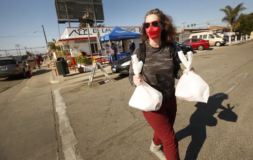 Column: The Tamale Festival Continues In Oxnard. 2 Sarah Cook Picks Up Her Ordered Selection Of Tamales At The Ocho Regiones Restaurant In Oxnard.