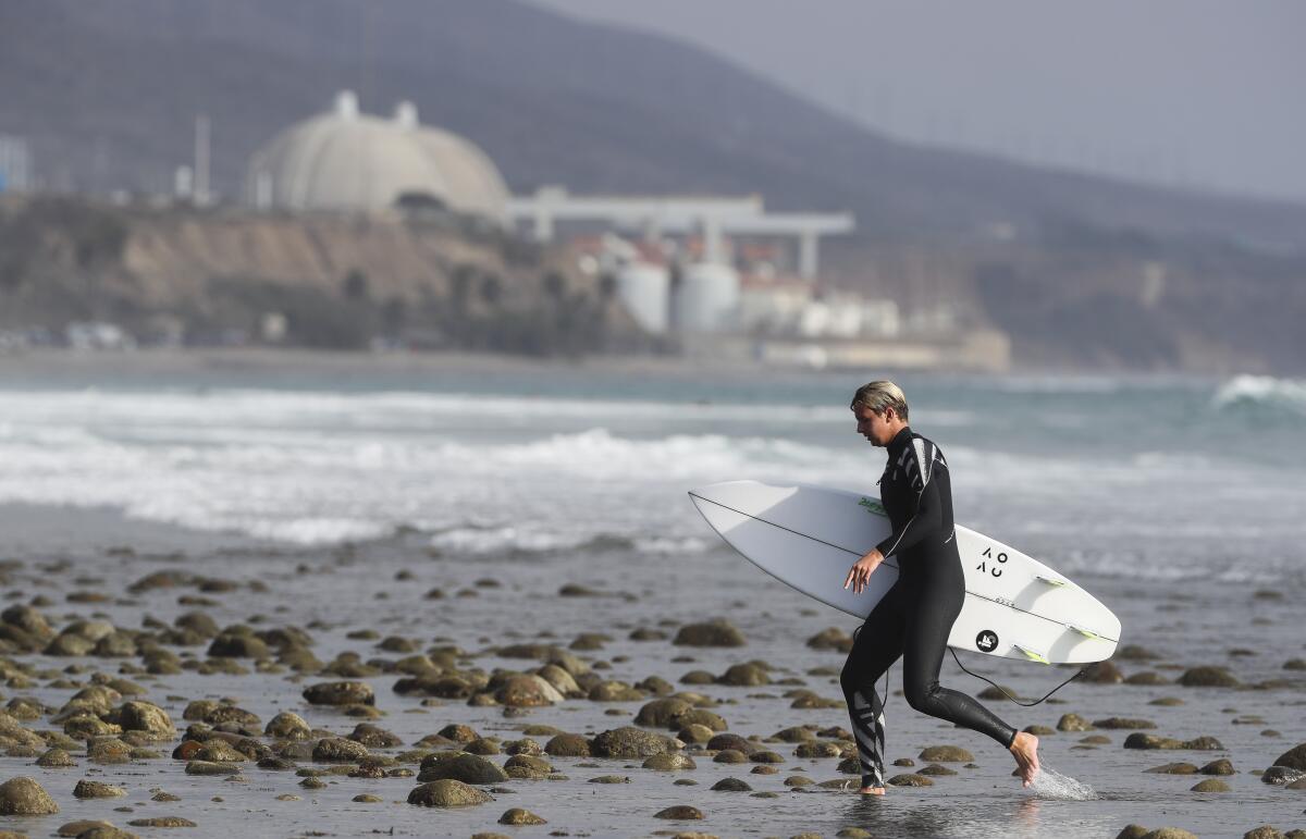 A surfer near the San Onofre Nuclear Generating Station  