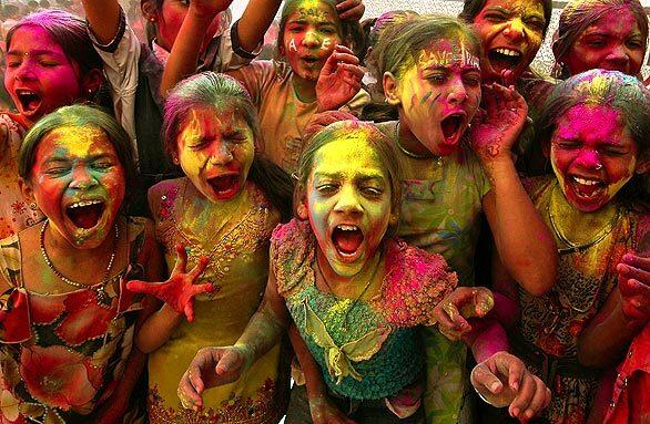 Schoolchildren celebrate Holi, the festival of colors, in Ahmadabad, India. Holi is held to welcome spring, and participants often douse themselves with colorful powder and water.