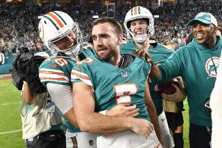 Miami Dolphins place kicker Jason Sanders, right, walks off the field with punter Jake Bailey (16) after an NFL football game against the Dallas Cowboys, Sunday, Dec. 24, 2023, in Miami Gardens, Fla. (AP Photo/Michael Laughlin)