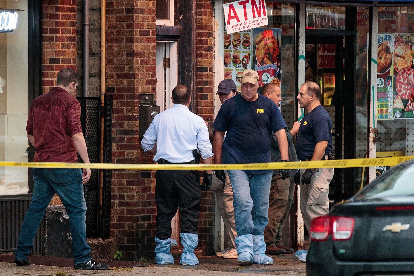 FBI and other law enforcement officials on Monday investigate a residence in Elizabeth, N.J., in connection to the Saturday bombings in New York and New Jersey.