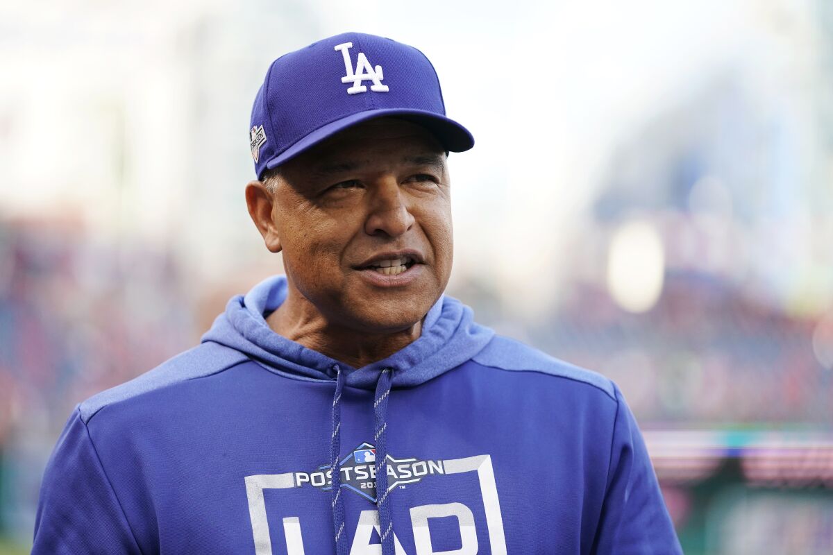 Dodgers manager Dave Roberts watches batting practice before Game 4 of the NLDS on Monday.