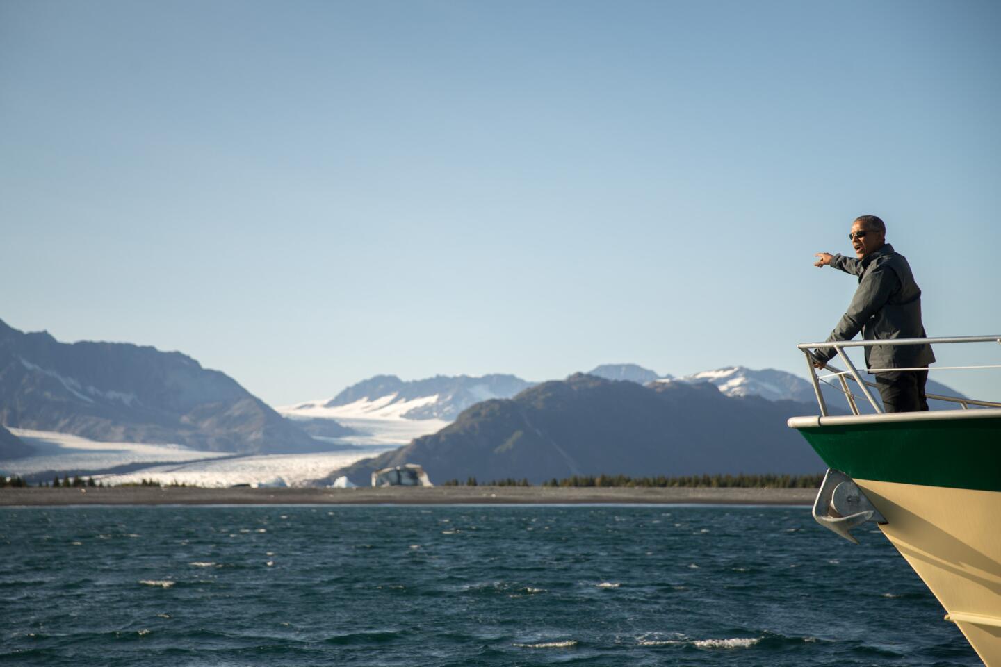 President Barack Obama looks at Bear Glacier, which has receded 1.8 miles in approximately 100 years, while on a boat tour to see the effects of global warming in Resurrection Cove, Alaska.