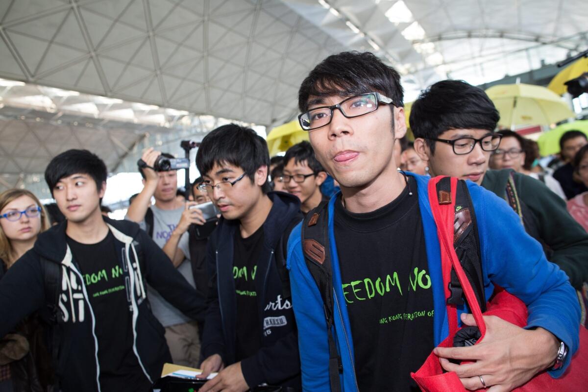 Hong Kong pro-democracy student leaders Alex Chow Yong-kang (2-L), Eason Chung Yiu-wa (2-R) and Nathan Law Kwun-chung, were prevented from boarding a plane to Beijing.