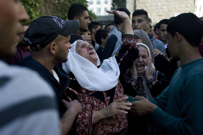 Two elderly Palestinian relatives of Nadim Nowarra, 17, who was killed Thursday during clashes with Isareli soldiers outside Ramallah.