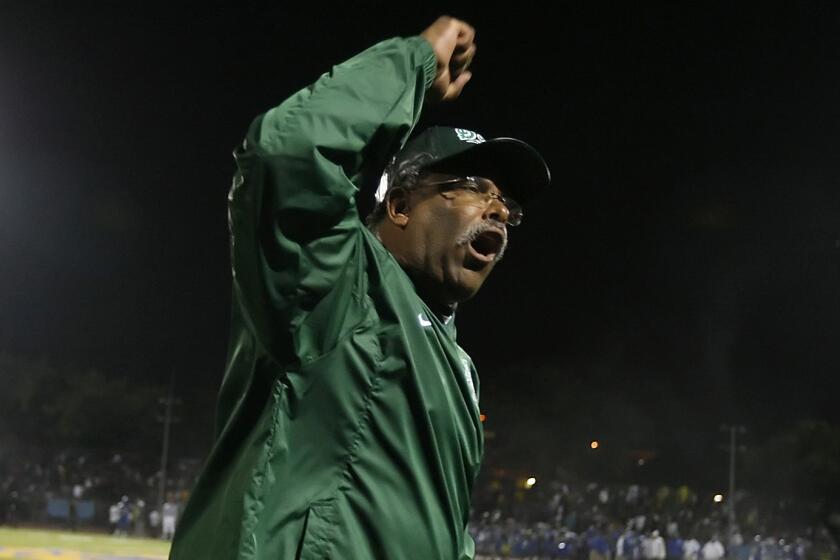 Former Dorsey football Coach Paul Knox reacts on the sideline before the opening kickoff against Crenshaw in November 2009.