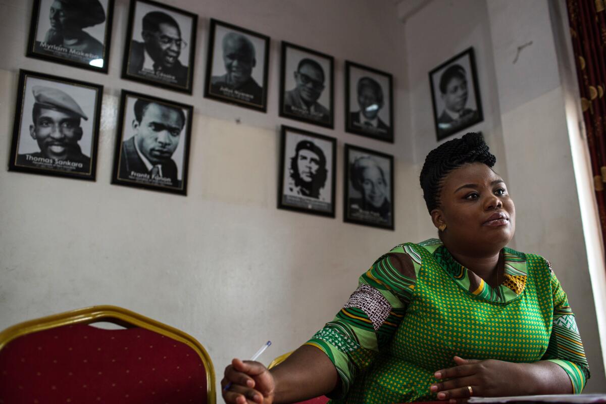 National Assembly candidate Charleine Tumba Muntu sits beneath photographs of people, including Nelson Mandela and Che Guevara, venerated by her party, the opposition African Democratic Union, at party headquarters in Kinshasa, Democratic Republic of Congo.