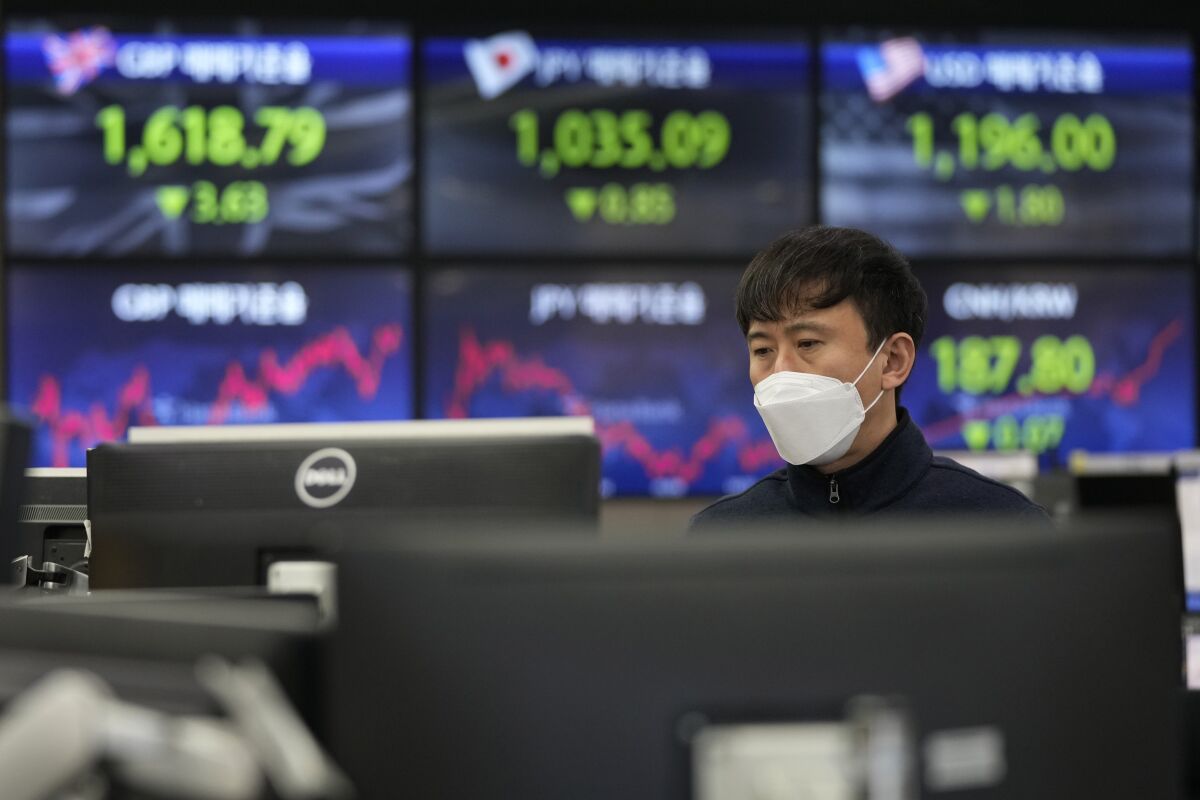 A currency trader watches monitors at the foreign exchange dealing room of the KEB Hana Bank headquarters in Seoul, South Korea, Thursday, Feb. 10, 2022. Asian shares mostly rose Thursday as investors tried to gauge U.S. inflation, tensions between Russia and Ukraine and the impact of the pandemic. (AP Photo/Ahn Young-joon)