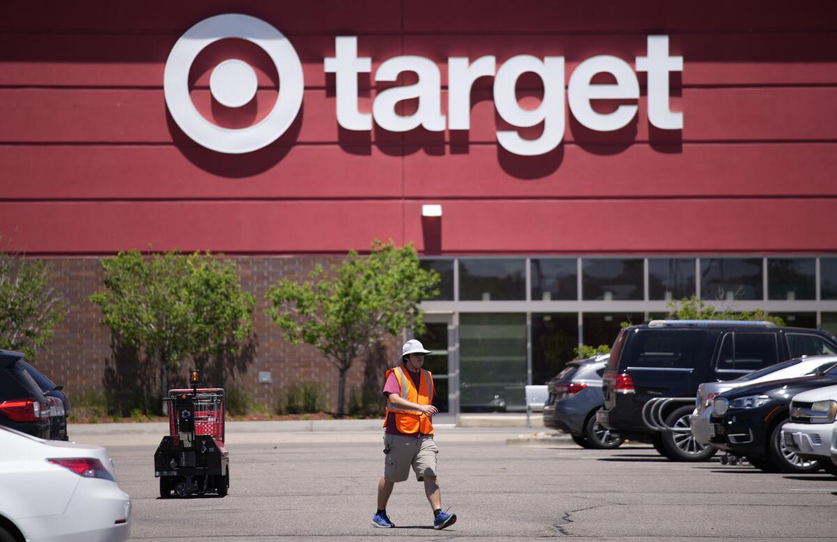 A worker walks in the parking lot outside a Target store.