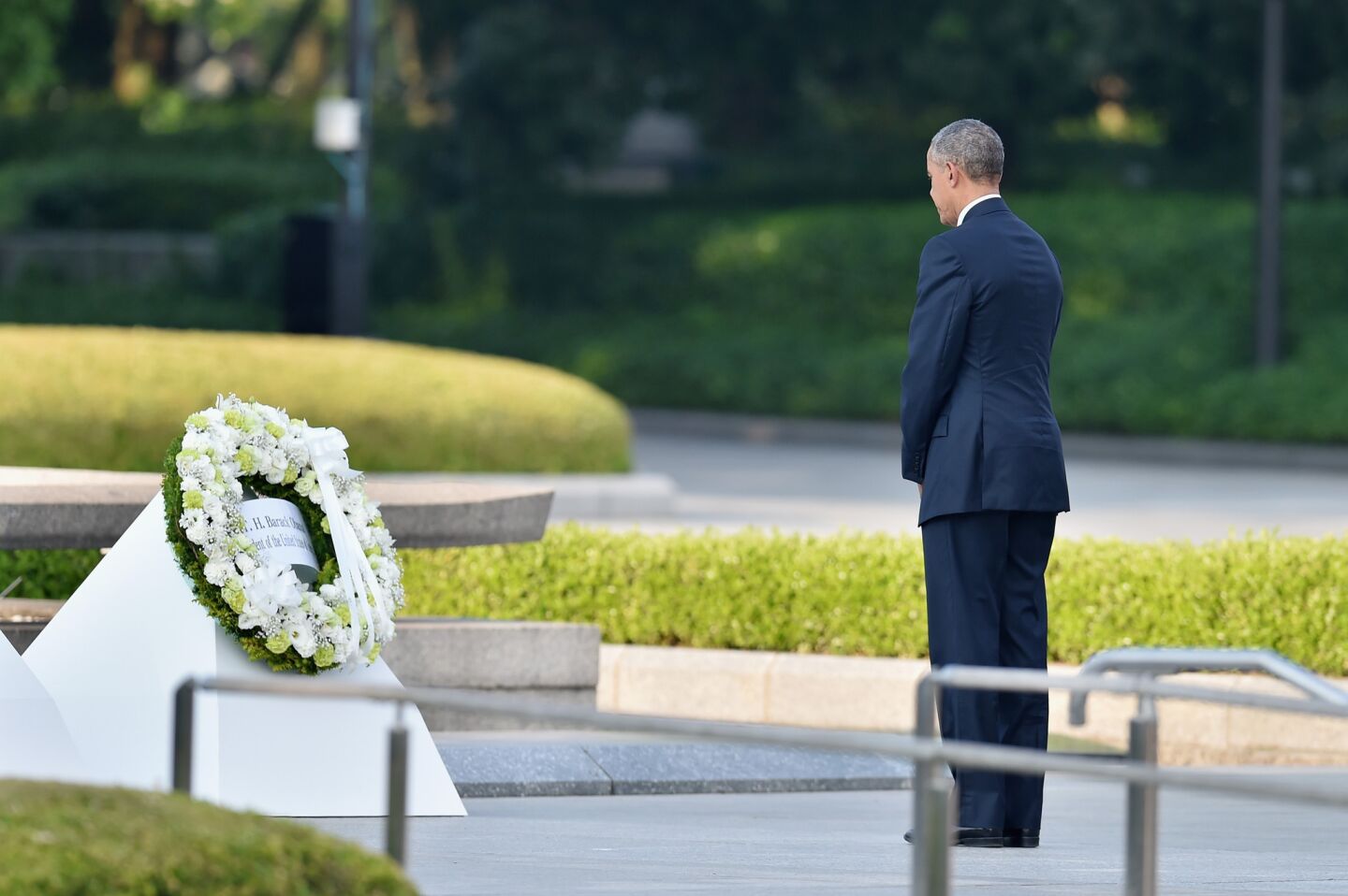 President Obama pauses after placing a wreath at Hiroshima Peace Memorial Park.