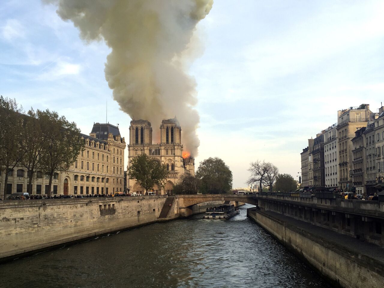 Massive plumes of smoke fill the air above Notre Dame Cathedral in Paris.