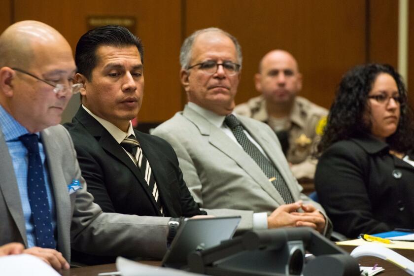 LOS ANGELES, CA - JANUARY 17, 2017: Defense attorney Bill Seki, from left, Los Angeles Police Department officer Rene Ponce, defense attorney Ira Salman and Los Angeles Police Department officer Irene Gomez listen to testimony during a preliminary hearing against Ponce and Gomez who are charged with covering up a crash involving a drunk driver and later filing a false police report. (Michael Owen Baker / For The Times)