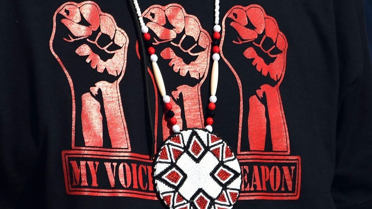Detail of a shirt reading "My Voice Is My Weapon" at a protest against the Dakota Access Pipeline near Cannon Ball, N.D.