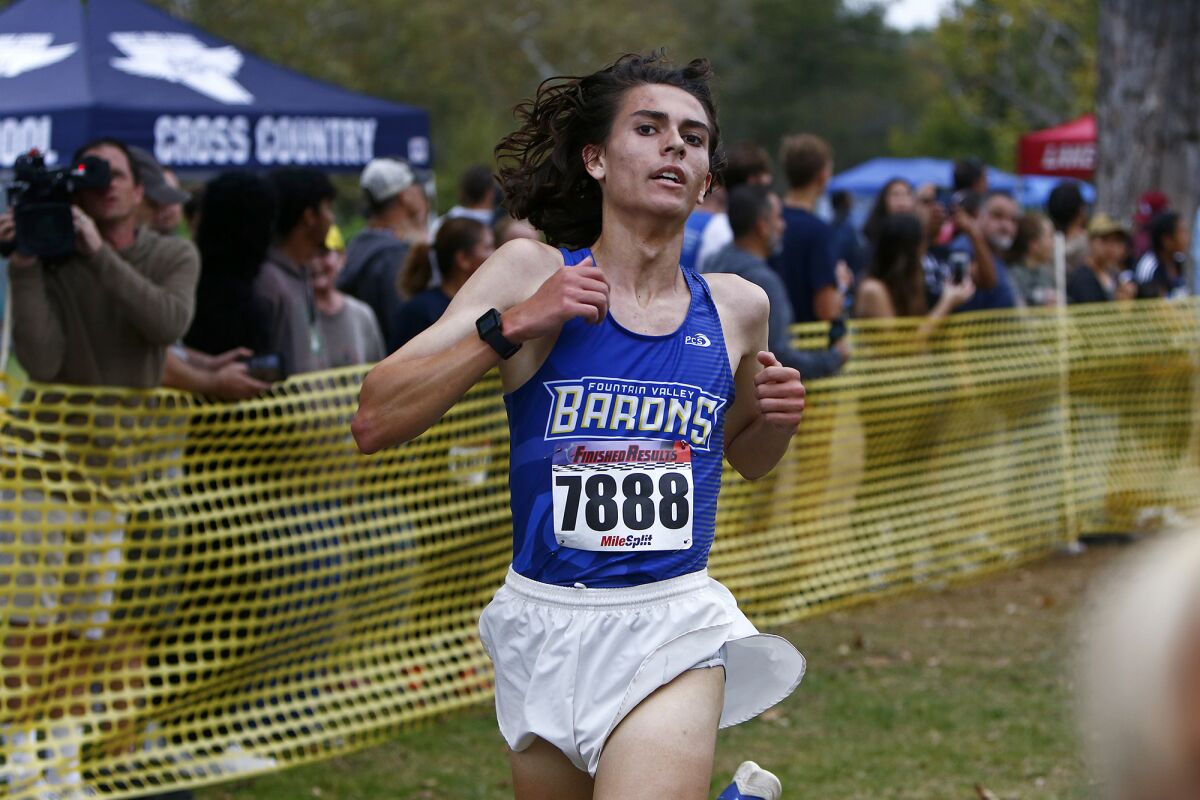 Fountain Valley's Luke Dias crosses the finish line during the Central Park Invitational on Saturday in Huntington Beach.