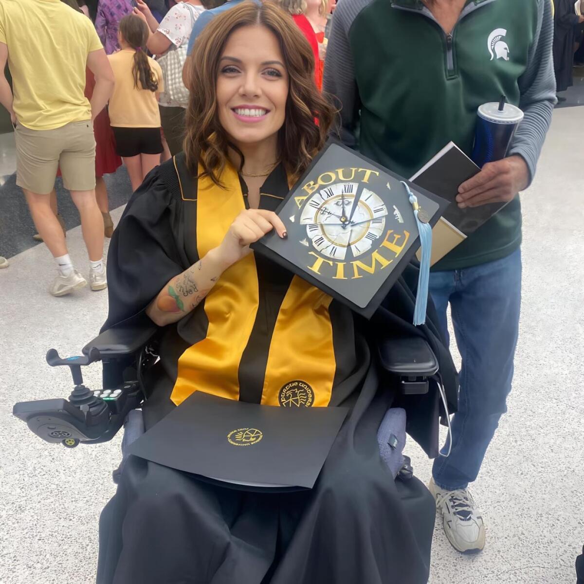 Erica Predum shows off her cap and diploma after graduating college last spring.
