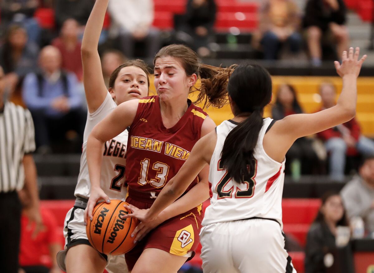 Ocean View's Angelina Bado (13) drives to the basket for a layup past two Segerstrom defenders on Wednesday.