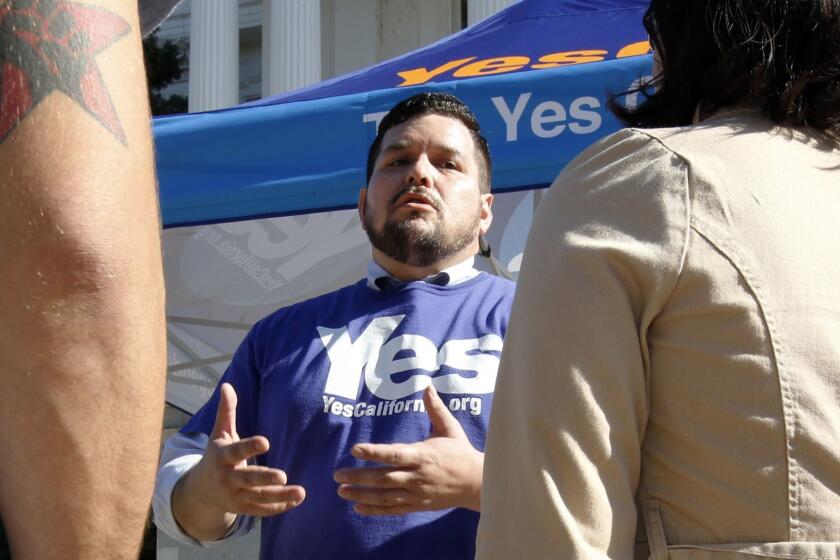 FILE - In this Nov. 9, 2016, file photo, Marcus Ruiz Evans, center, vice president of The Yes California Independence Campaign, talks to about California succeeding from the United States and becoming its own nation in Sacramento, Calif. Ruiz Evan's said Monday, April 17, 2017, that he notified officials that he intends to withdraw the California Nationhood ballot measure. (AP Photo/Rich Pedroncelli, File)