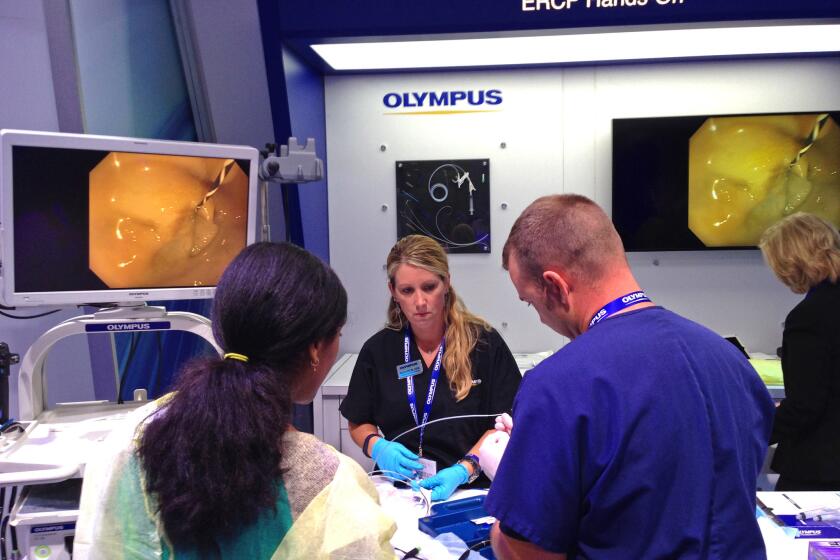 A hands-on demonstration of medical equipment, including a medical scope, at the Digestive Disease Week conference in May 2015. Three recent outbreaks are among dozens of injury reports in a federal database that detail the risk of serious infection from contaminated scopes.