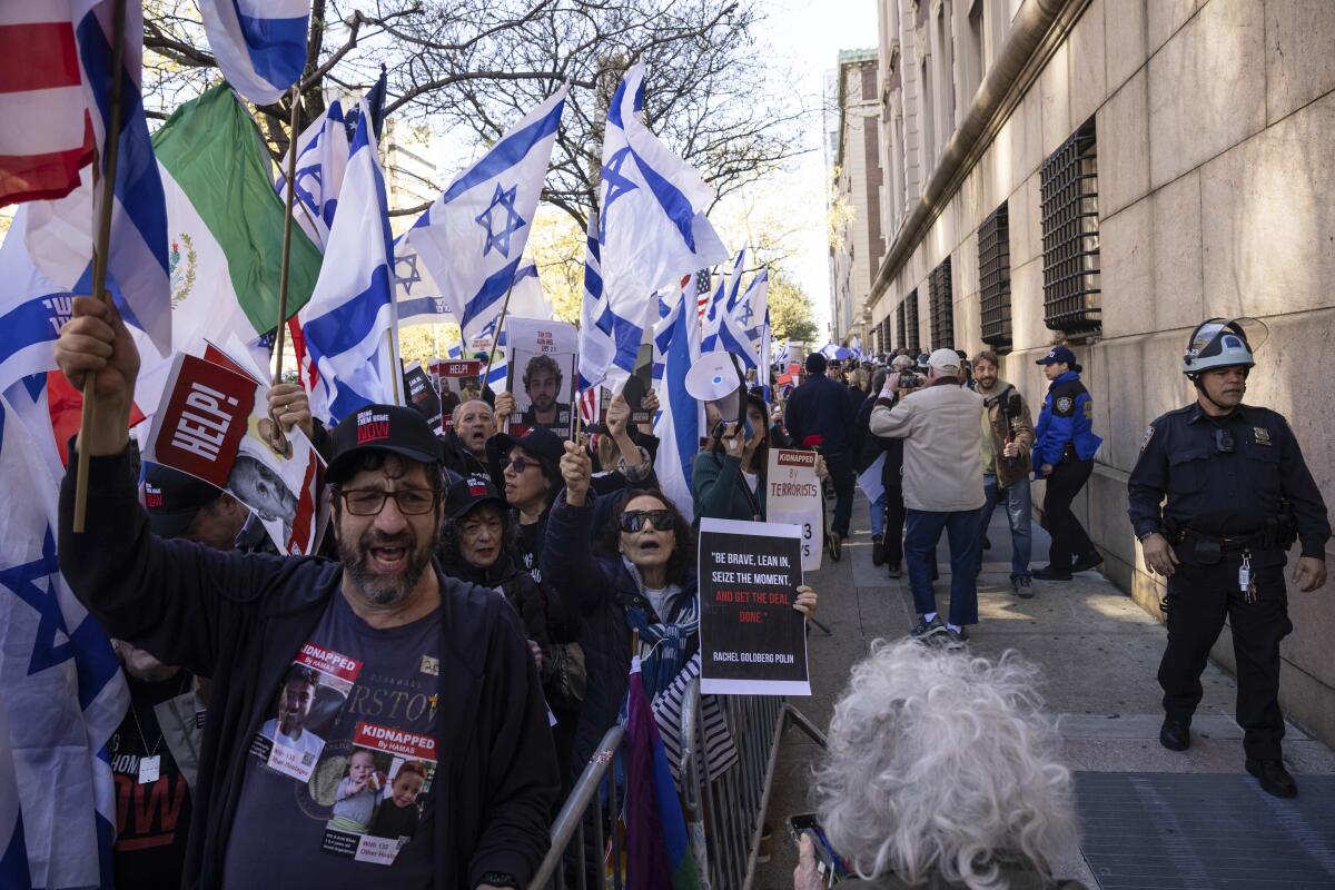 Marchers hold up Israeli flags.
