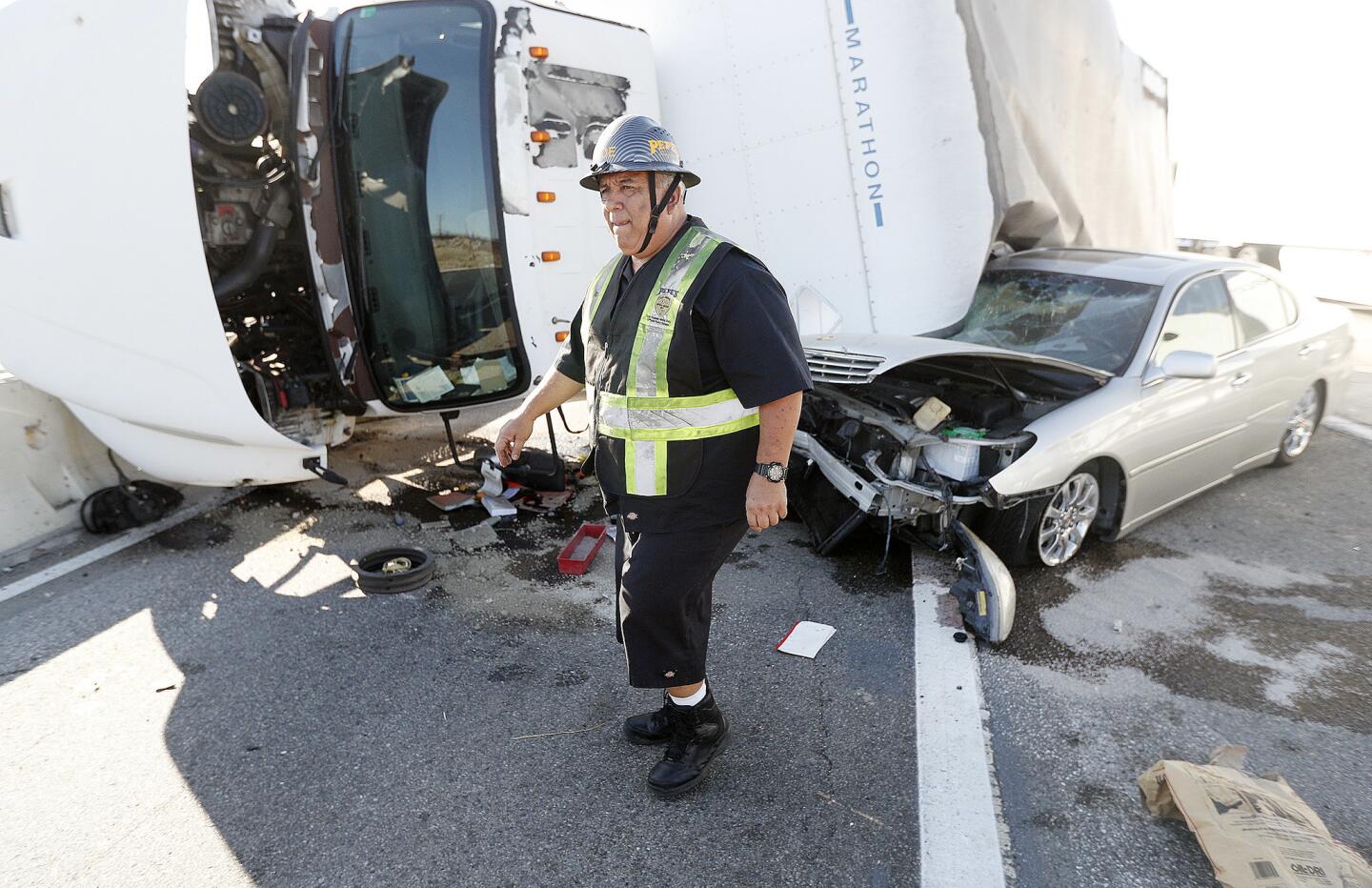 Joe Acosta, with Pepe's towing, sizes up the extraction of a car and a box truck tangled with each other at the southbound Interstate 5 exit at Burbank Boulevard in Burbank on Thursday, September 13, 2018. Minor injuries occurred with a backup in southbound lanes extending to Glenoaks Boulevard.