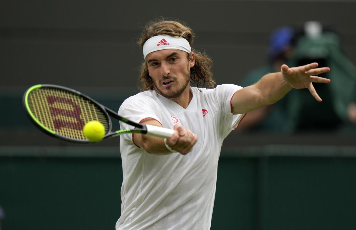 Stefanos Tsitsipas hits a forehand.