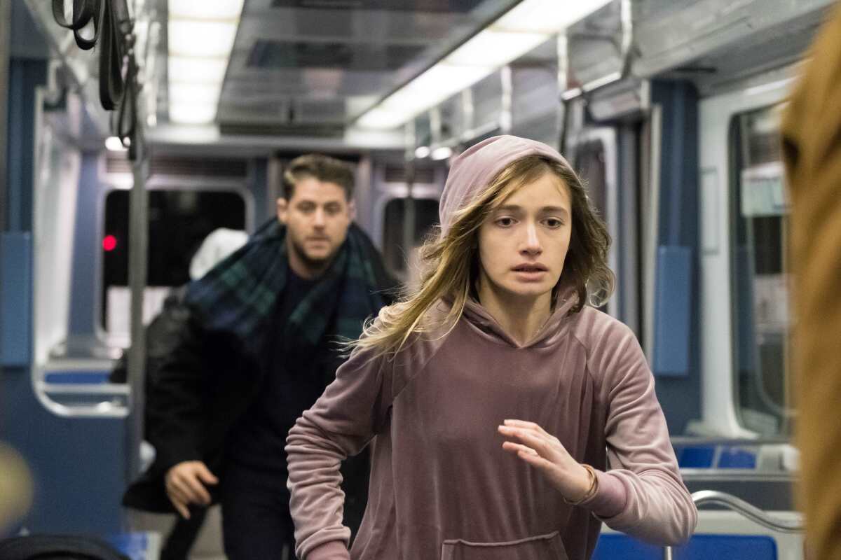 Jon Abrahams and Nicole Elizabeth Berger running in a train car in "Clover."