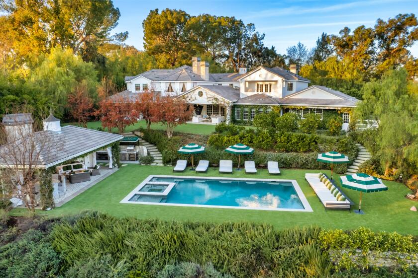 The sprawling compound includes a main house, guesthouse, barn, riding arena and a lush backyard with a swimming pool and spa.