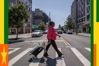 Winsome Pendergrass carries her goods from the farmers market to her home in Brooklyn, New York on Sept. 2, 2023. 