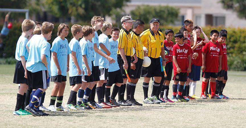 Players from Newport Heights and Wilson line up with the referees before the boys' 5-6 gold division championship game at the Daily Pilot Cup.