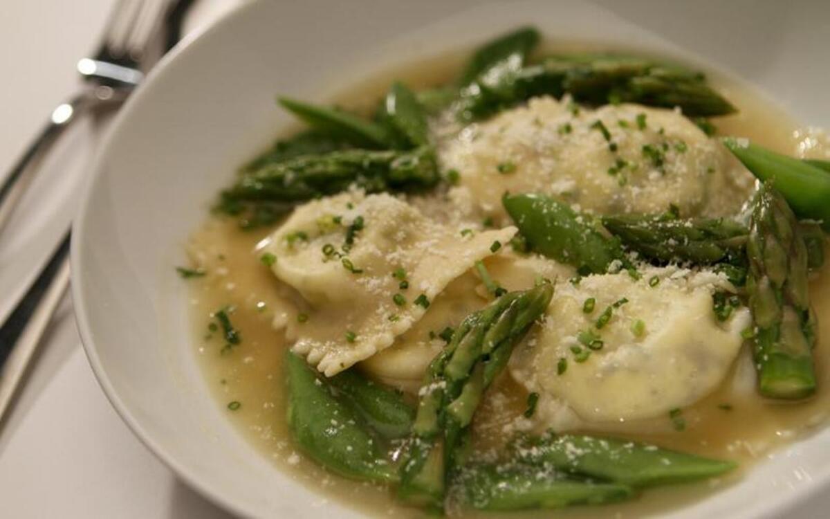 Spring vegetables in Parmesan broth with goat cheese ravioli