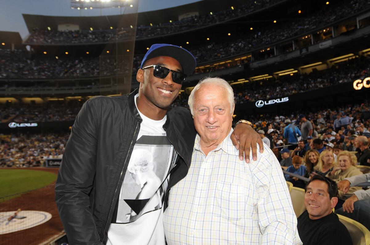 Lakers legend Kobe Bryant poses for a photo with Dodgers great Tommy Lasorda during a game at Dodger Stadium in July 2013.