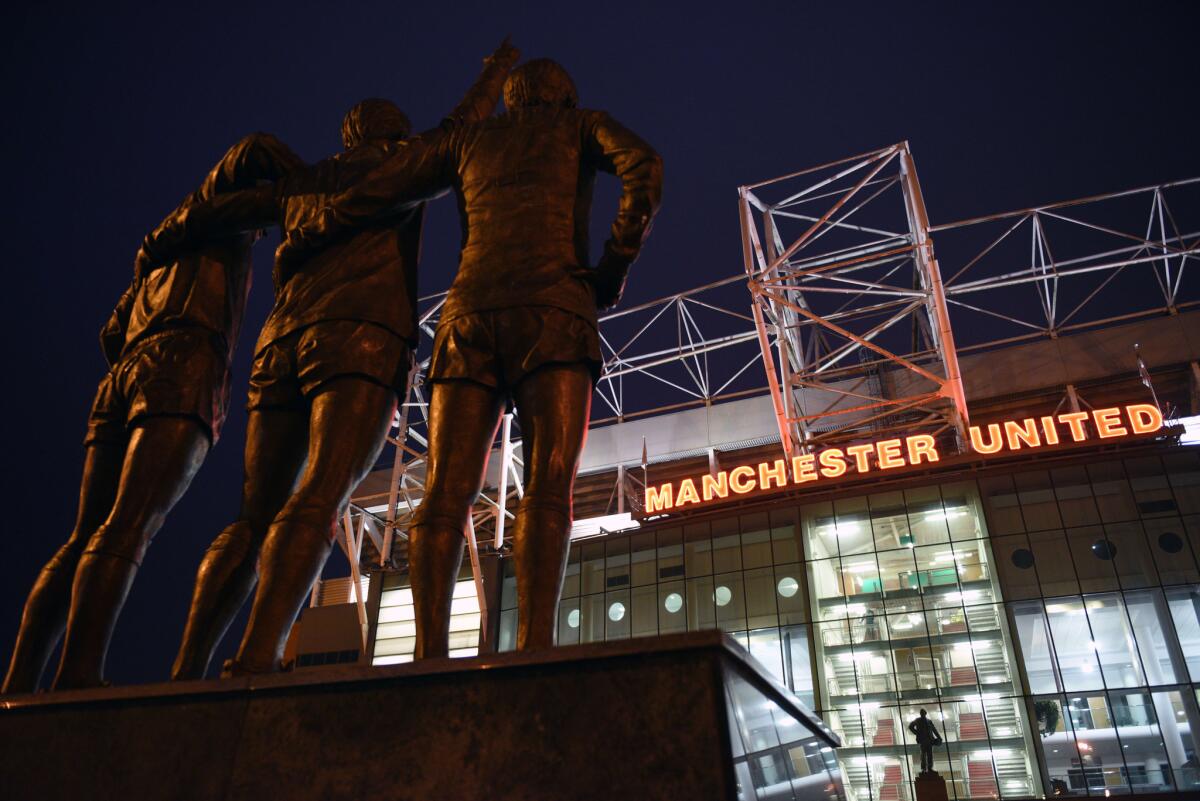 'The United Trinity' statue of former Manchester United players George Best, Denis Law, and Bobby Charlton are seen outside Old Trafford.