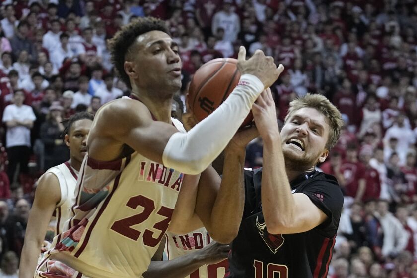 Indiana forward Trayce Jackson-Davis (23) and Rutgers guard Cam Spencer (10) vie for the ball during the second half of an NCAA college basketball game Tuesday, Feb. 7, 2023, in Bloomington, Ind. (AP Photo/Darron Cummings)