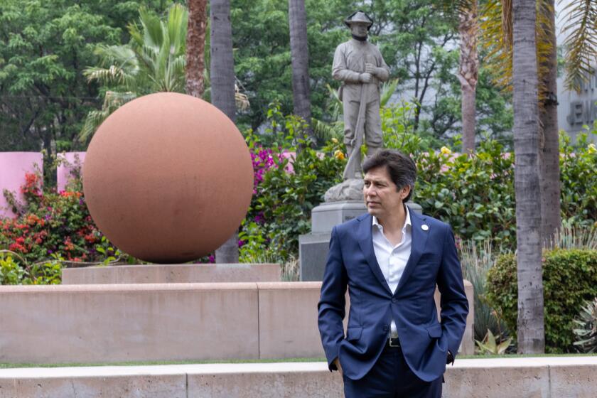 Los Angeles, CA - June 19: With Spanish-American War Memorial, also known as the 7th Regiment Monument, in the background, LA Councilmember Kevin de Leon arrives for a press conference to announce intent to rename Pershing Square to Biddy Mason Park in Pershing Square Wednesday, June 19, 2024 in Los Angeles, CA. (Brian van der Brug / Los Angeles Times)