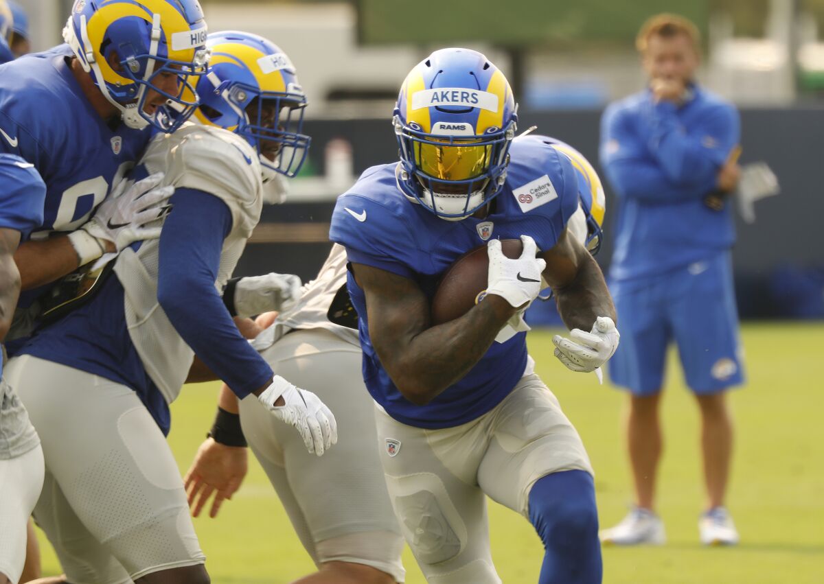 Rams rookie running back Cam Akers carries the ball during a practice session.