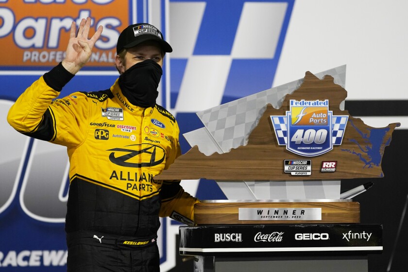 Brad Keselowski poses with the trophy as he celebrates winning a NASCAR Cup Series playoff race Sept. 12, 2020.