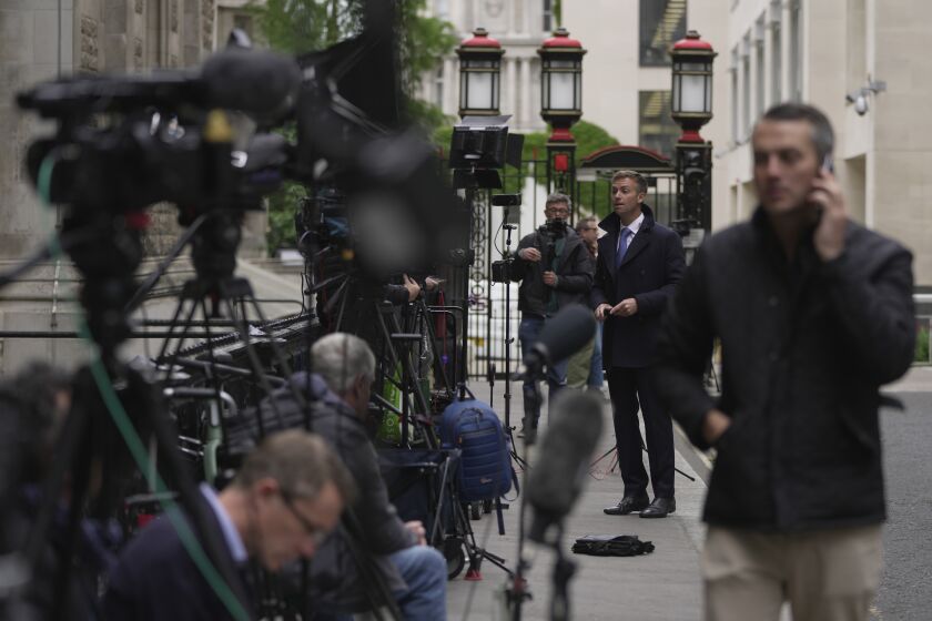 Media waits outside the High Court for the expected arrival of Prince Harry in London, Monday, June 5, 2023. Prince Harry has five active legal cases, three of them involving his battle with the British tabloids. He is expected to testify in London's High Court; if he takes the witness stand, he'll be the first member of the royal family to testify in court since the late 19th century. (AP Photo/Kin Cheung)