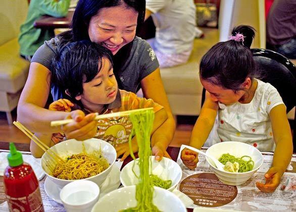 Danya Yu and her kids, Nikolai and Melanie Ochaeta, enjoy the noodles at Bamboodles, a San Gabriel restaurant that is at the forefront of a house-made noodle renaissance in the area.