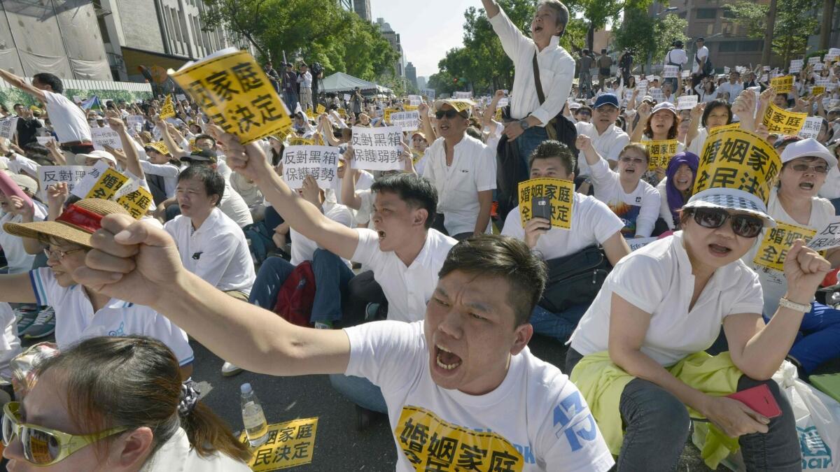 Protesters chant anti-same-sex marriage slogans during 2016 protests outside parliament in Taipei, Taiwan.