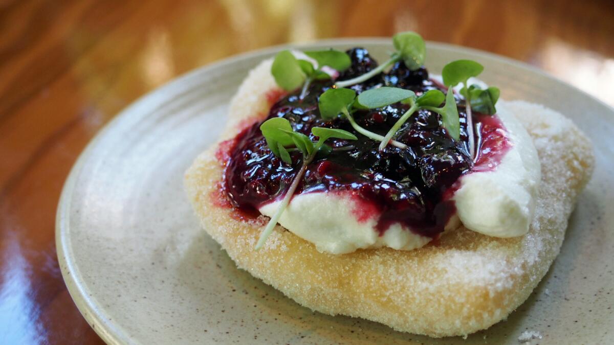 A pocket of sweet montanara (fried pizza dough) is topped with sweet ricotta and berries at Vinoteca, a new wine bar opening at Culina at the Four Seasons Los Angeles at Beverly Hills.