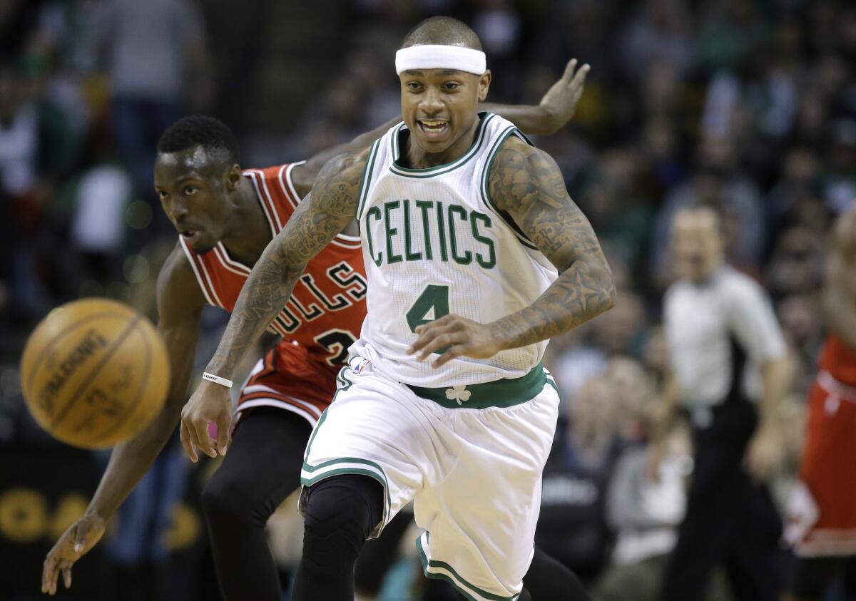 Boston Celtics guard Isaiah Thomas (4) and Chicago Bulls guard Jerian Grant (2) chase the ball in the first quarter of an NBA basketball game, Sunday, March 12, 2017, in Boston. The Celtics won 100-80. (AP Photo/Steven Senne)