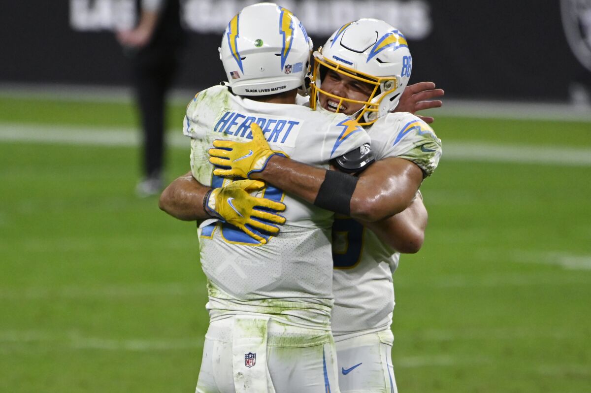Chargers tight end Hunter Henry embraces quarterback Justin Herbert.