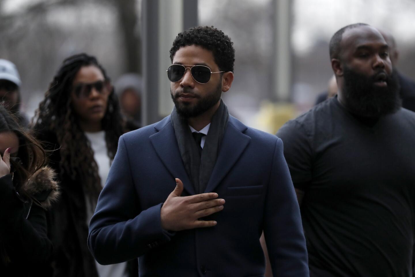 Jussie Smollett gestures to supporters who chant for him as he arrives for a hearing at the Leighton Criminal Court Building in Chicago on March 14, 2019.