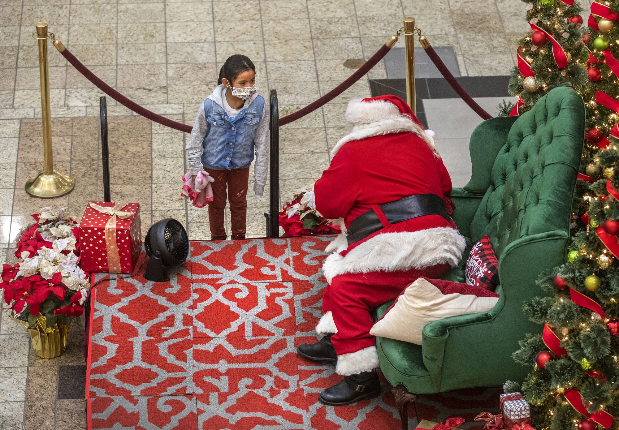 Jayleen Evangelista, 6, talks to Santa Claus 